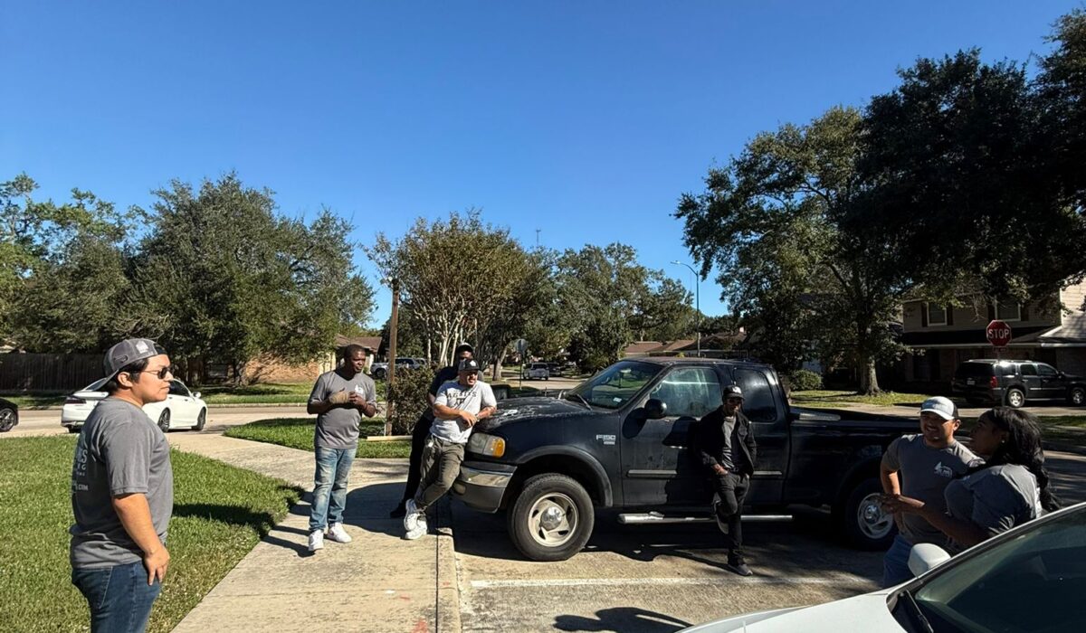 DC Pines Roofing bilingual crew huddle in a Houston neighborhood before an install