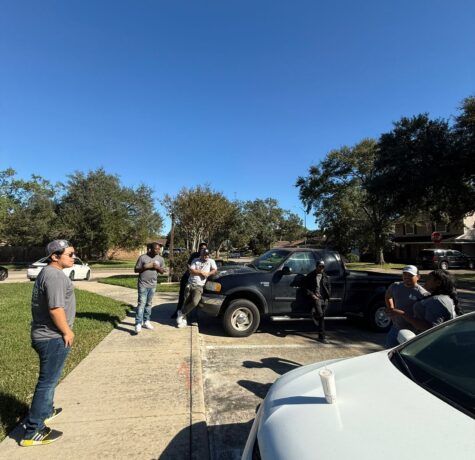 DC Pines Roofing bilingual crew huddle in a Houston neighborhood before an install