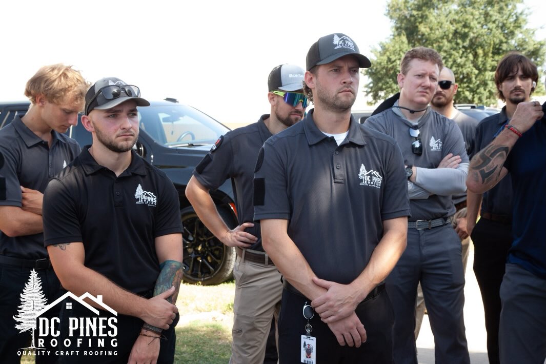 DC Pines Roofing crew members in company polo shirts during a visit to Camp Hope in Houston