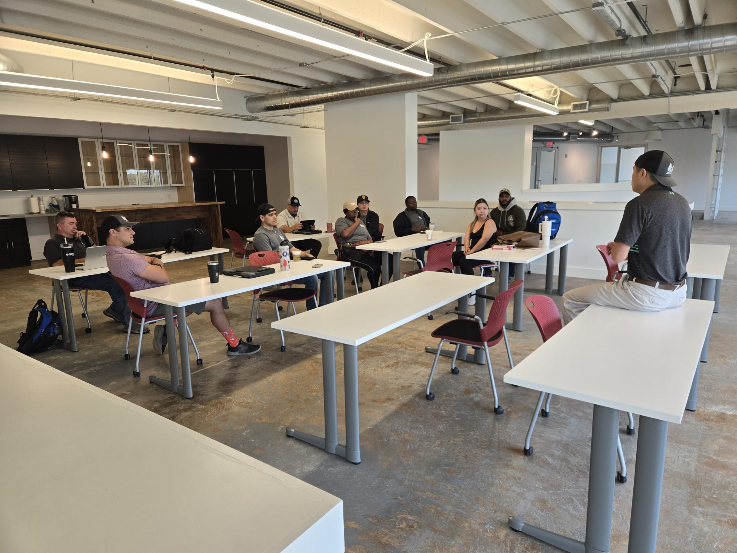DC Pines Roofing team members in a training session at the company education center in Houston