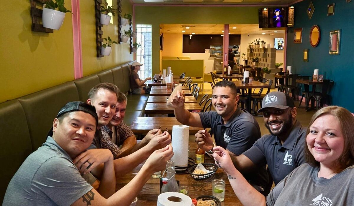 DC Pines Roofing team members sharing a meal together at a local Houston restaurant