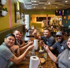 DC Pines Roofing team members sharing a meal together at a local Houston restaurant