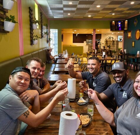 DC Pines Roofing team members sharing a meal together at a local Houston restaurant