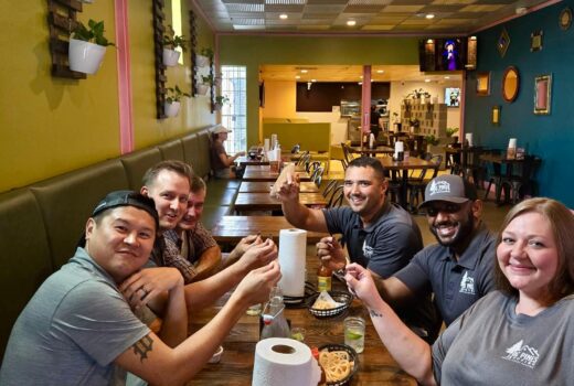 DC Pines Roofing team members sharing a meal together at a local Houston restaurant