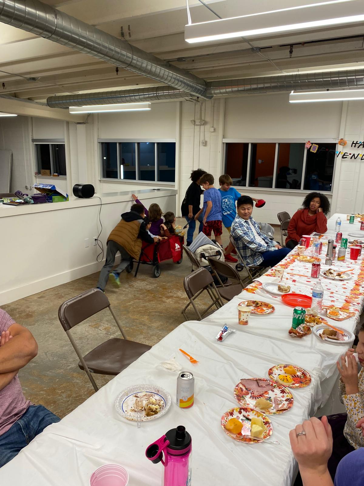 DC Pines Roofing team and their families gathered around the Friendsgiving table in Houston