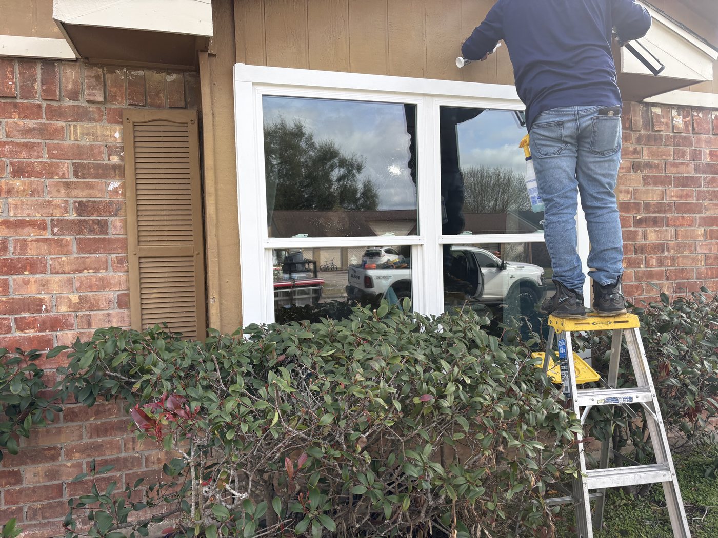 Installers fitting replacement windows on a Houston home