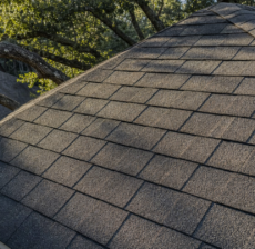 Aged charcoal asphalt shingle roof on a Houston home showing sun-fade from Houston roof shingle heat aging