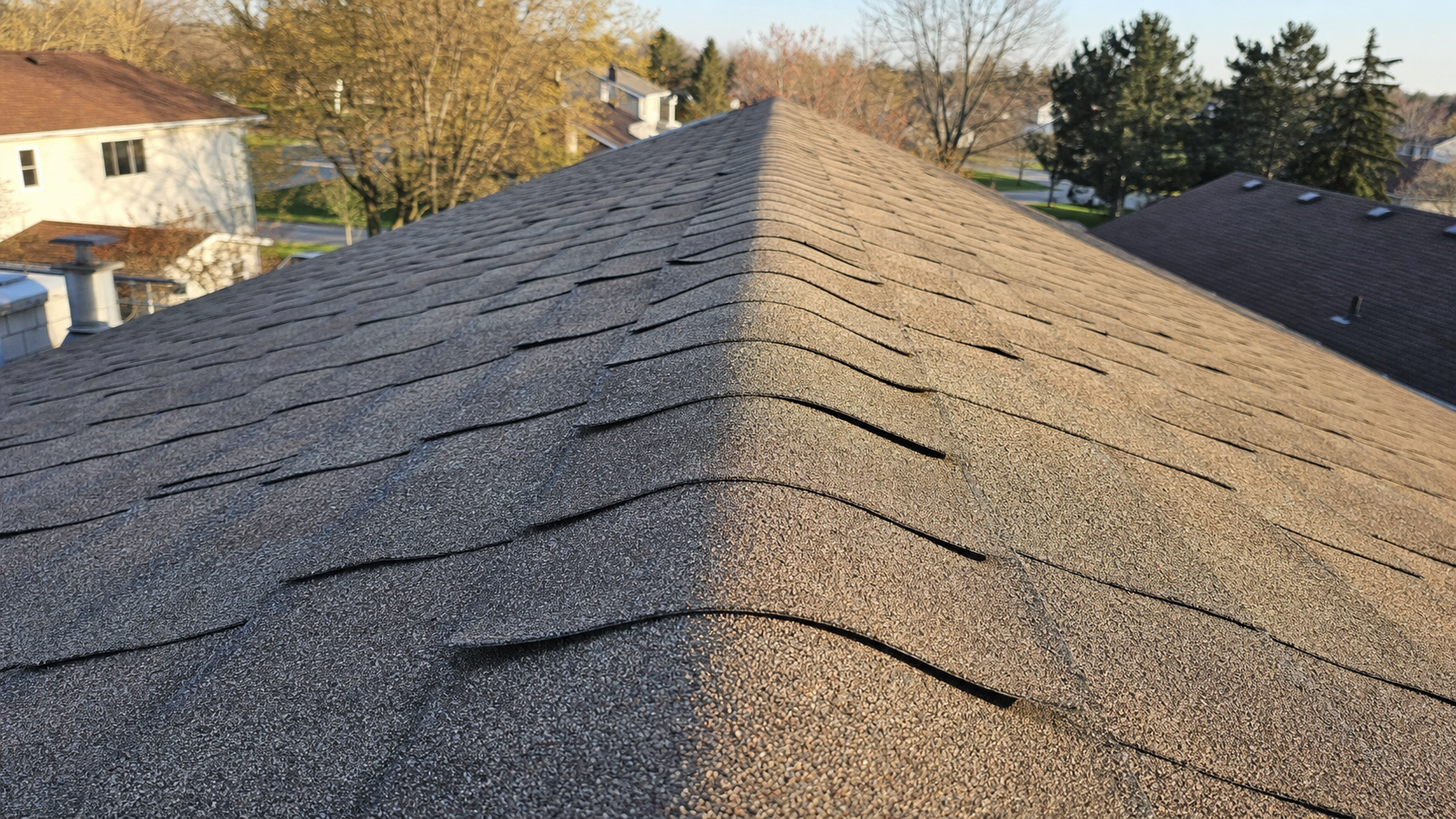 Curling and cupping shingles on a Houston roof after years of thermal cycling