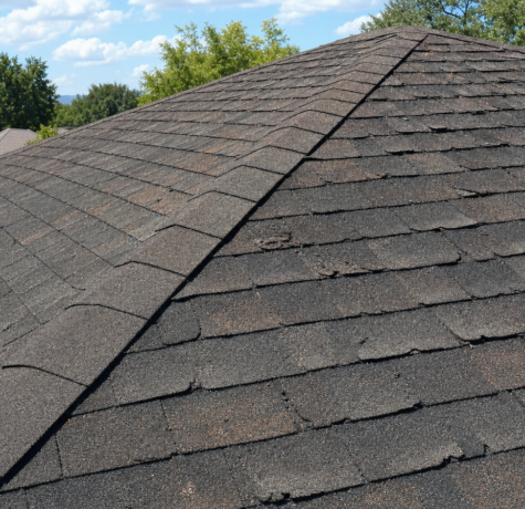 Aging Houston asphalt roof illustrating common Houston roof myths about lifespan and warranty