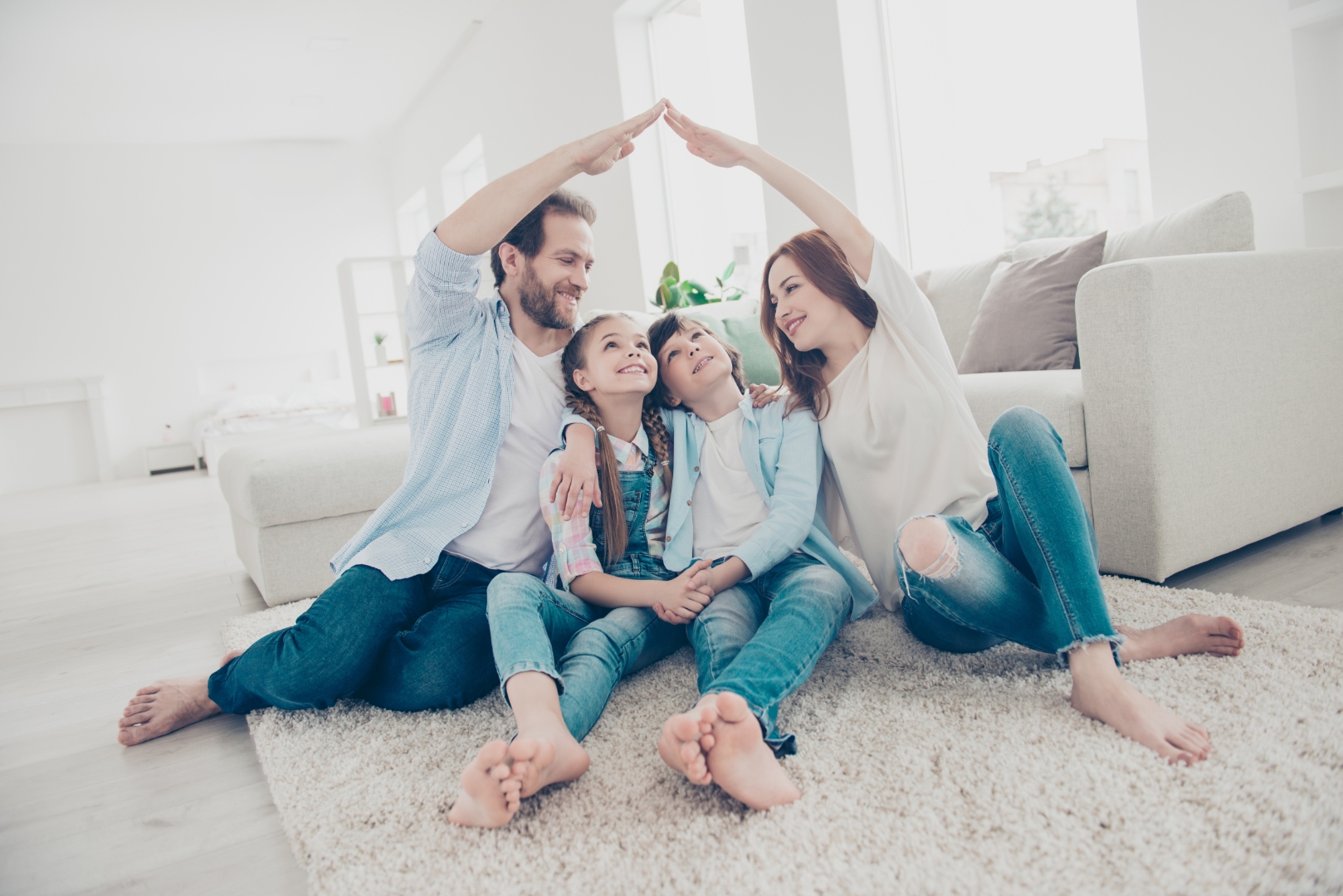 A Houston family sitting under a roof of their own making — the home you are protecting.