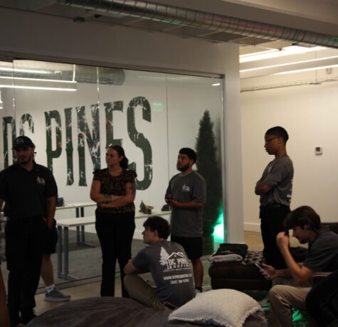 The DC Pines Roofing team gathered together during a Houston office meeting, capturing the collaborative culture that starts every crew day