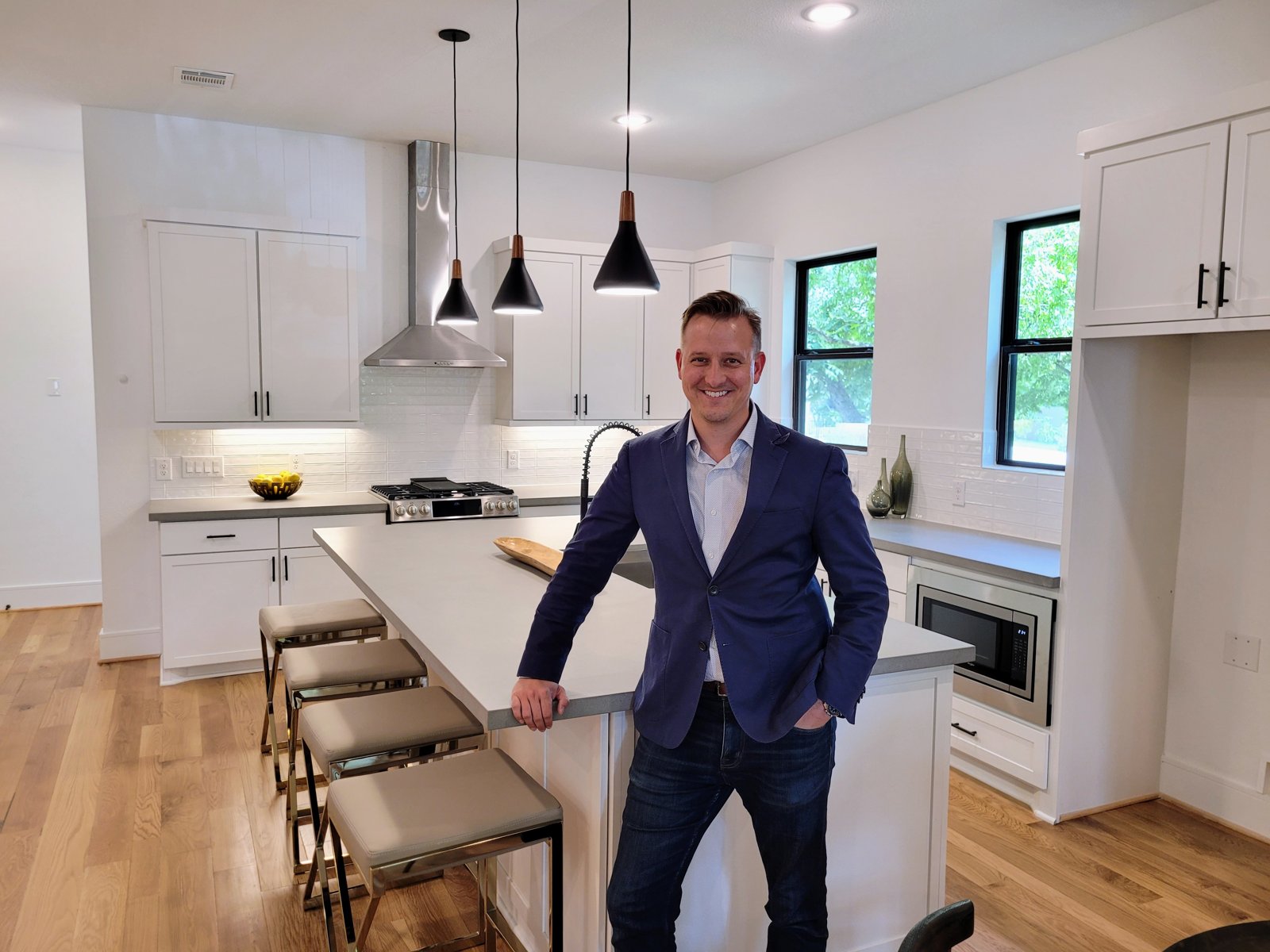 DC Pines Roofing owner inside a Houston-area home reviewing a finished renovation as part of the company's quality standard