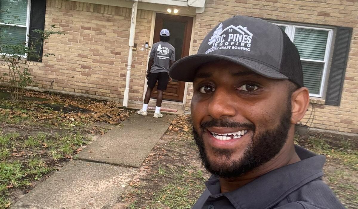 DC Pines Roofing crew member on a Houston jobsite reviewing next steps