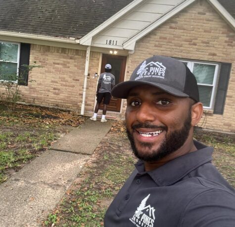 DC Pines Roofing crew member on a Houston jobsite reviewing next steps