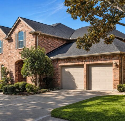 Two-story Houston brick home with seamless aluminum gutters and downspouts