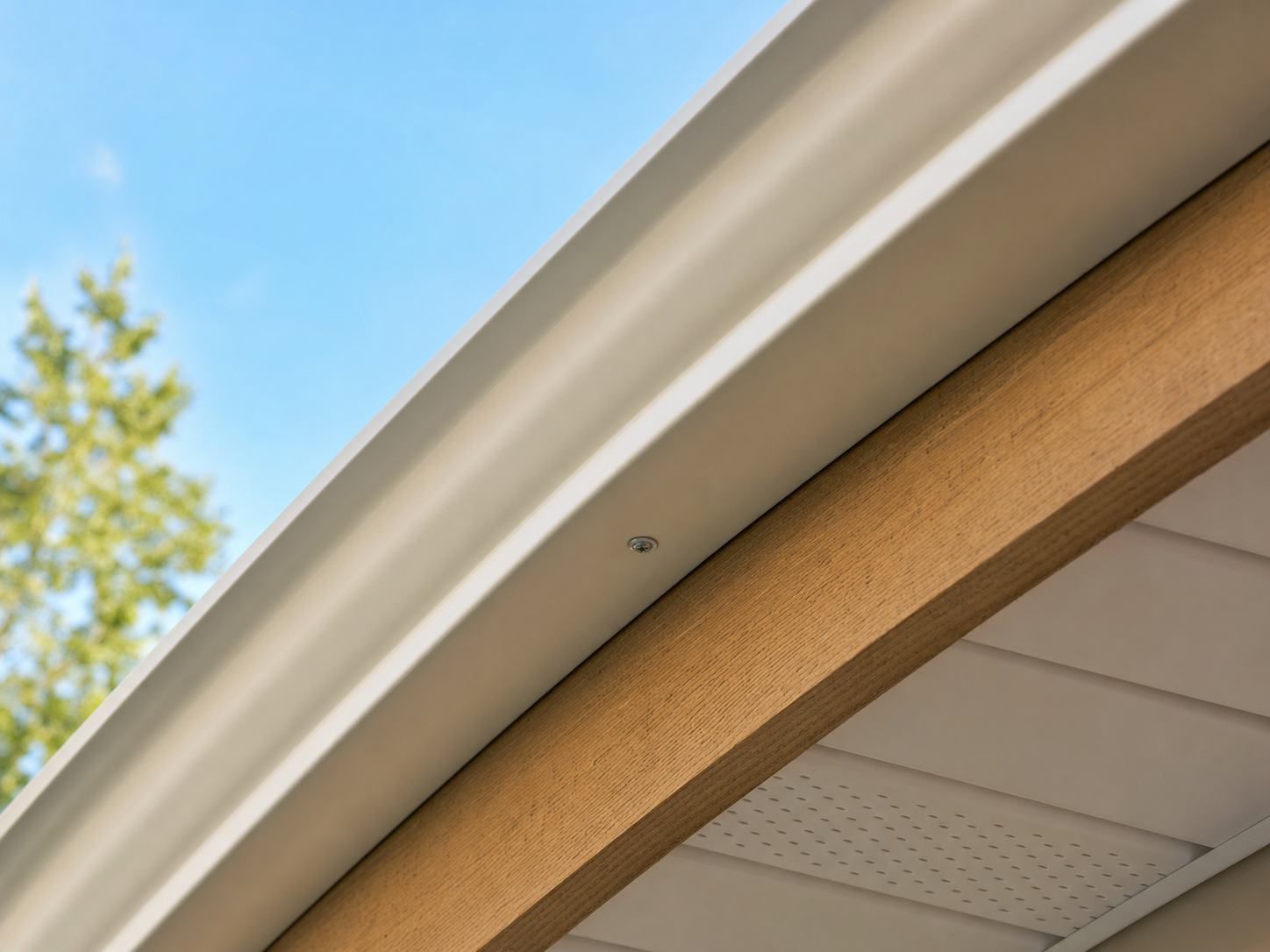 Close-up of a hidden hanger inside a Houston aluminum gutter with the aluminum trough front-face visible