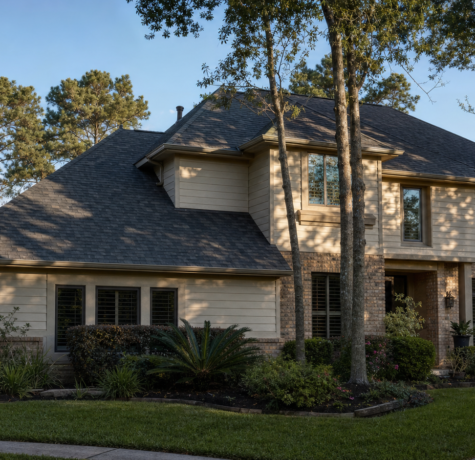 Well-installed asphalt shingle roof on a Houston suburban home viewed from the street