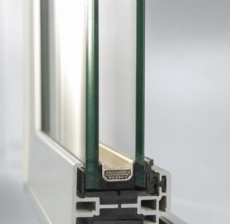 Cross section of a modern double-pane insulated glass unit showing warm-edge spacer bar and sealed cavity for a Houston triple pane vs double pane windows heat climate comparison