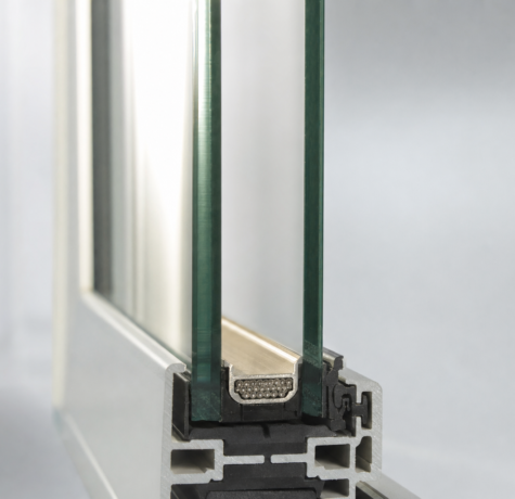 Cross section of a modern double-pane insulated glass unit showing warm-edge spacer bar and sealed cavity for a Houston triple pane vs double pane windows heat climate comparison