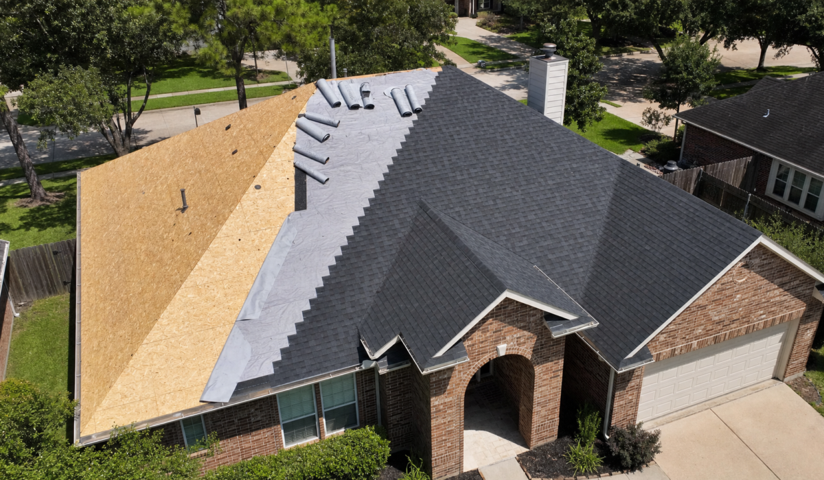 Wide view of a partially reroofed Houston home with clean plywood decking and synthetic vs felt underlayment visible in overlapping courses