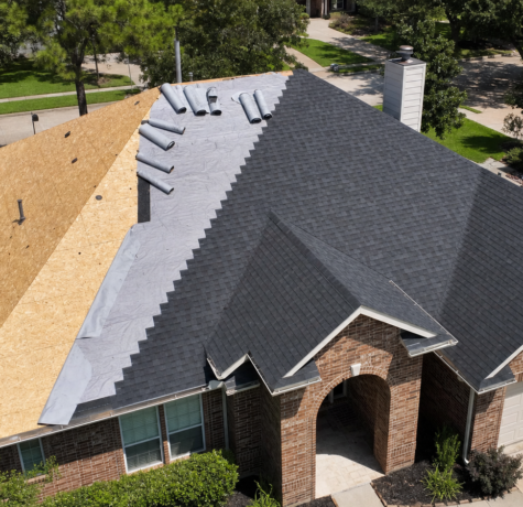 Wide view of a partially reroofed Houston home with clean plywood decking and synthetic vs felt underlayment visible in overlapping courses