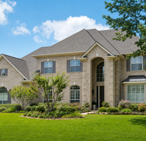Suburban Houston home exterior with a well-maintained shingle roof, framed as a resale-ready listing photo