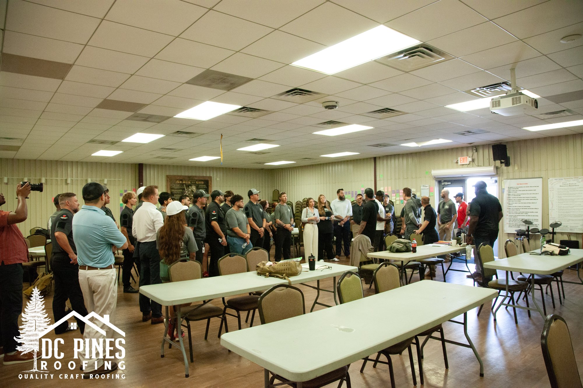 DC Pines team inside a meeting hall on the Camp Hope campus