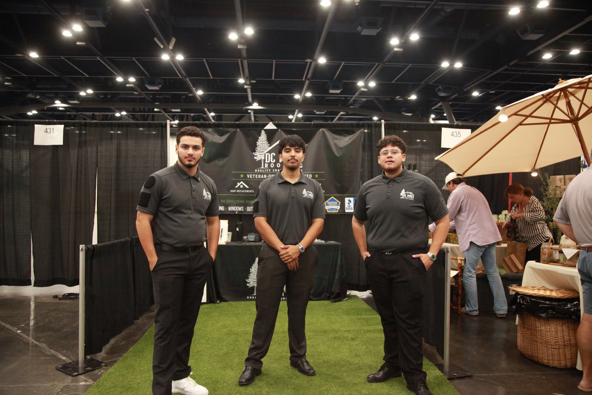 DC Pines Roofing team members at the company's home show booth in Houston